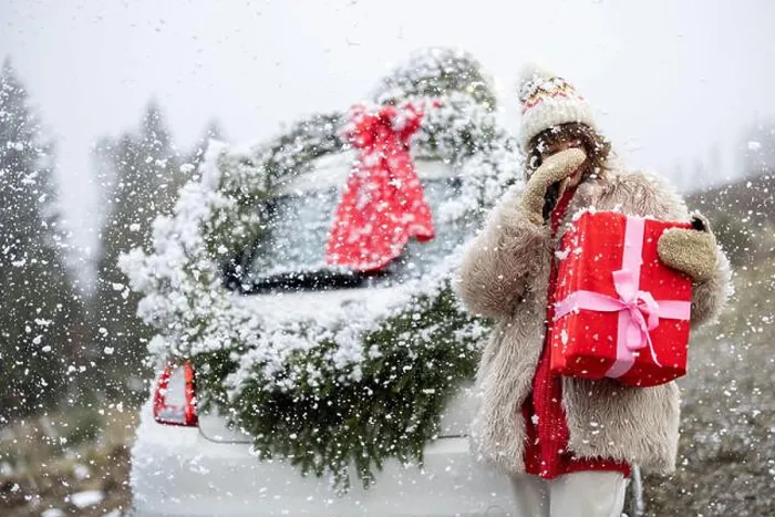 Framed Print : Woman travels by car with presents and Christmas wreath on the mountain road Framed Print : Woman travels by car with presents and Christmas wreath on the mountain road
