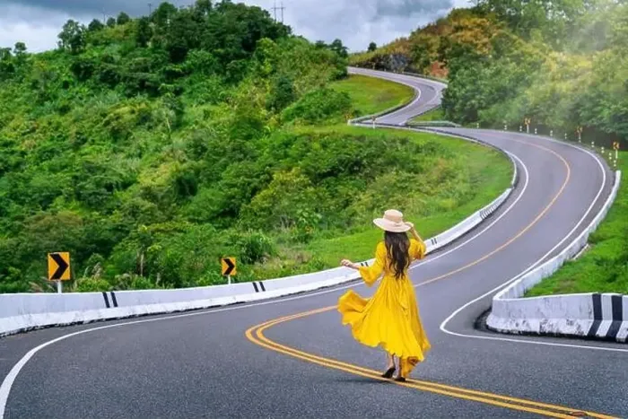 Framed Print : Woman walking on road no.3 or sky road over top of mountains with green jungle in Nan province, Thailand Framed Print : Woman walking on road no.3 or sky road over top of mountains with green jungle in Nan province, Thailand