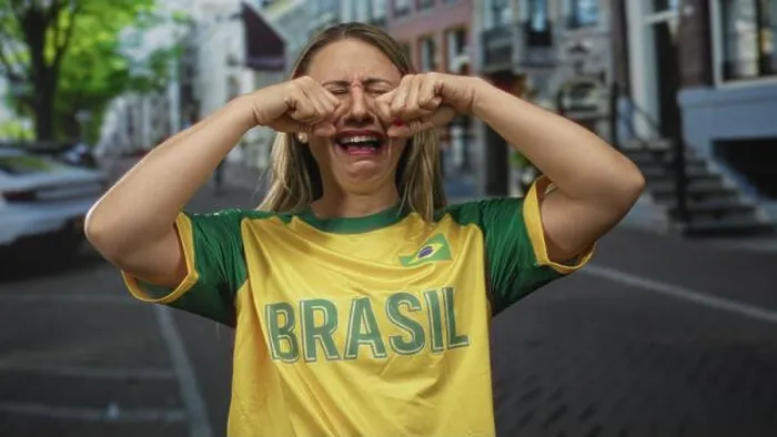 Framed Print : Woman in yellow jersey rubs fists against her eyes on street; sadness disappointment longing reflection Framed Print : Woman in yellow jersey rubs fists against her eyes on street; sadness disappointment longing reflection