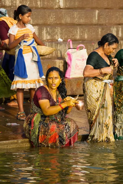 Framed Print : Women come to bathe and pray in the holy waters of the Ganges River in the Hindu city of Varanasi, India Framed Print : Women come to bathe and pray in the holy waters of the Ganges River in the Hindu city of Varanasi, India