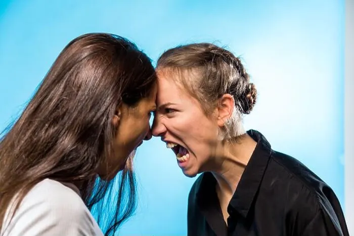Framed Print : Two women screaming at one another looking at each other face to face. Profile Framed Print : Two women screaming at one another looking at each other face to face. Profile