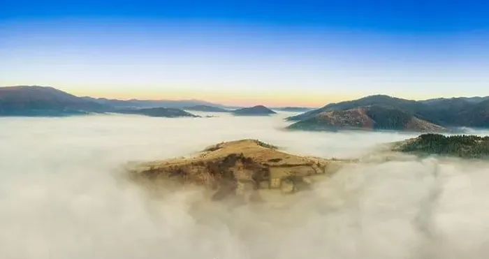 Framed Print : Wonderful autumn landscape in the mountains at dawn. Drone view of the autumn forest and low clouds