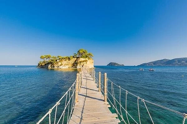 Wooden bridge from Agios Sostis leading to small rocky island. Bay of Laganas, Zakynthos island, Greece