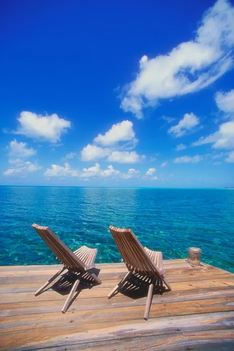 Framed Print : Wooden deck chairs looking out towards the horizon in the Caribbean Framed Print : Wooden deck chairs looking out towards the horizon in the Caribbean