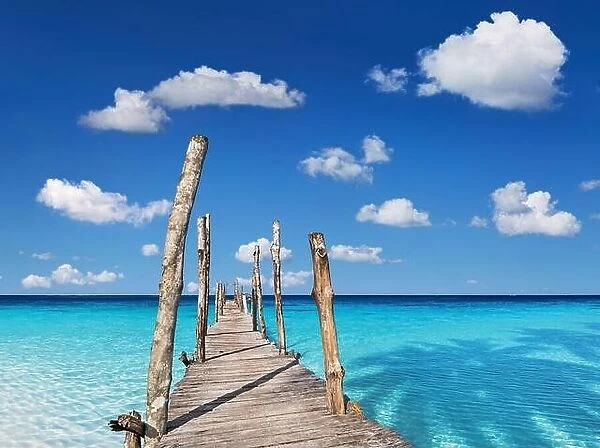 Wooden pier on the tropical island, clear sea and blue sky