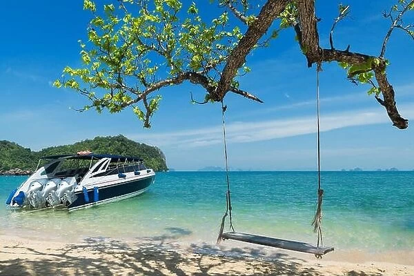 Wooden swing chair hanging on tree near beach at island in Phuket, Thailand. Summer Vacation Travel and Holiday concept