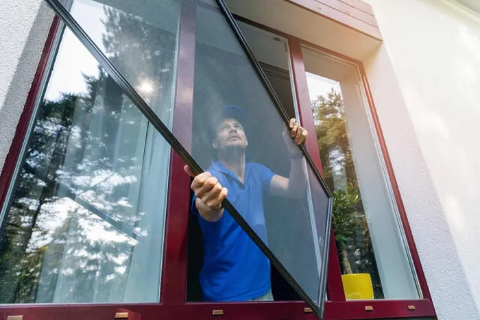 Framed Print : worker installing mosquito net wire screen on plastic pvc window Framed Print : worker installing mosquito net wire screen on plastic pvc window