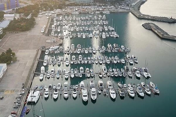 Yatch harbor marina pier and boat dock yatchs and vessels awaiting the open sea. Aerial drone view looking straight down above T-Head