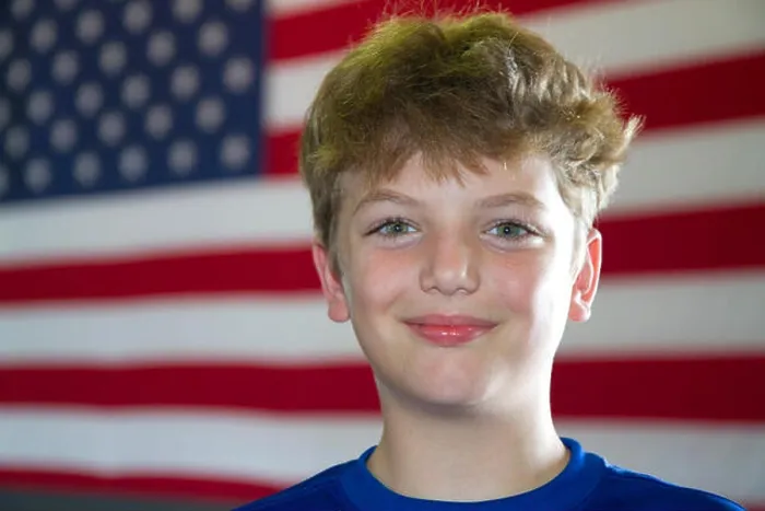Framed Print : Ten year old american boy standing in front of an american flag in Charleston, South Carolina, USA. MR Framed Print : Ten year old american boy standing in front of an american flag in Charleston, South Carolina, USA. MR