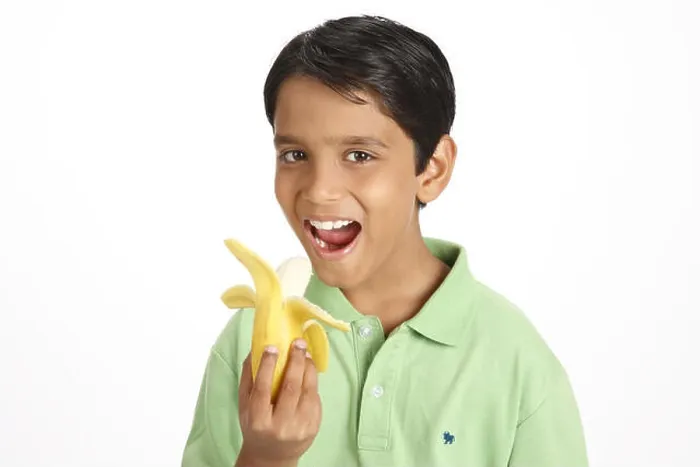 Framed Print : Ten year old boy showing half peeled yellow banana holding in hand MR#703V Framed Print : Ten year old boy showing half peeled yellow banana holding in hand MR#703V