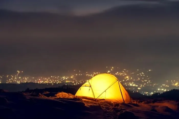 Framed Print : Yellow tent lighted from the inside against the backdrop of glowing city lights in fog. Amazing snowy landscape. Tourists camp in winter mountains Framed Print : Yellow tent lighted from the inside against the backdrop of glowing city lights in fog. Amazing snowy landscape. Tourists camp in winter mountains