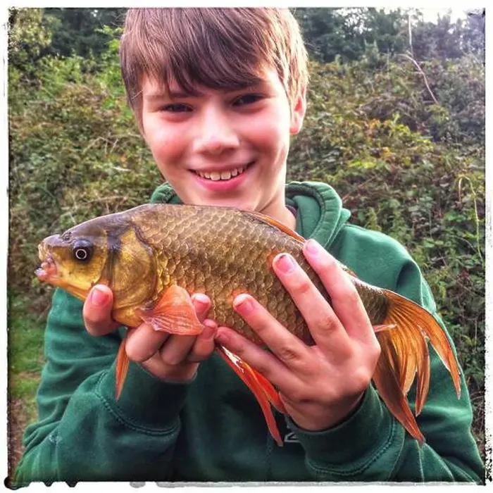 Framed Print : Young angler holding carp Framed Print : Young angler holding carp