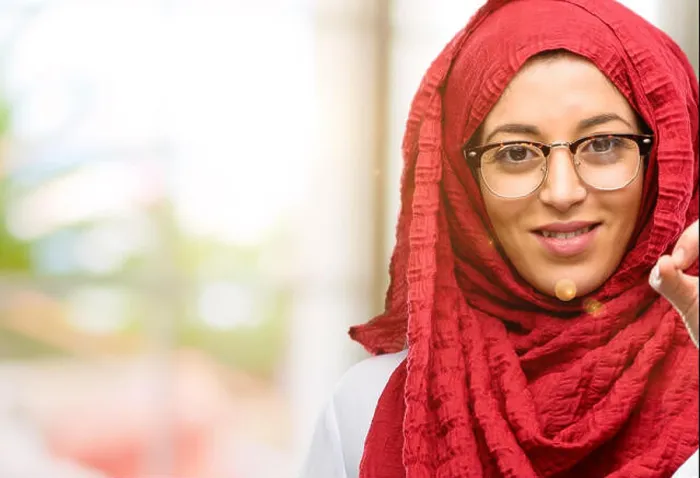 Framed Print : Young arab woman wearing hijab doing ok sign with hand, approve gesture Framed Print : Young arab woman wearing hijab doing ok sign with hand, approve gesture