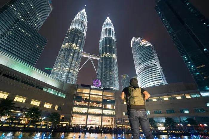 Framed Print : Young Asian man traveler wearing casual with backpack bag enjoy amazing weekends. Looking away to building in Kuala Lumpur, Malaysia. Asia Framed Print : Young Asian man traveler wearing casual with backpack bag enjoy amazing weekends. Looking away to building in Kuala Lumpur, Malaysia. Asia