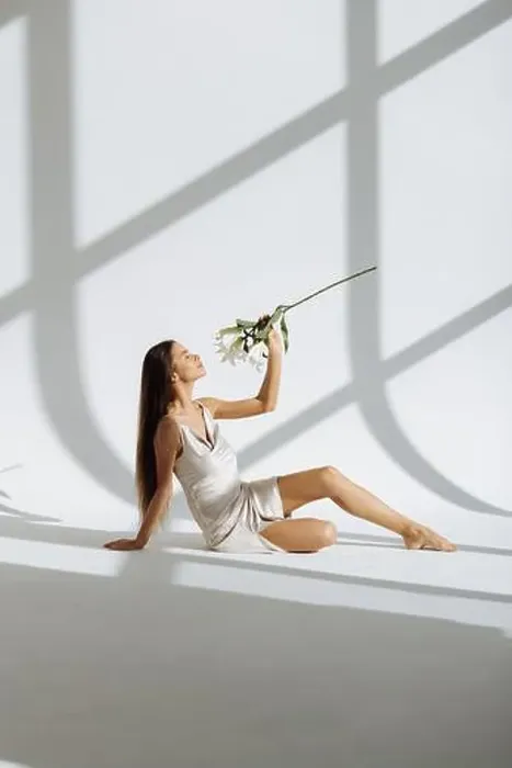 Framed Print : Young beautiful woman with flowers peonies. A girl sits on the floor with flowers. Flowers cover the body Framed Print : Young beautiful woman with flowers peonies. A girl sits on the floor with flowers. Flowers cover the body