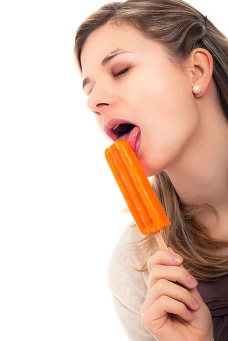 Framed Print : Young beautiful woman licking ice pop, isolated on white background Framed Print : Young beautiful woman licking ice pop, isolated on white background