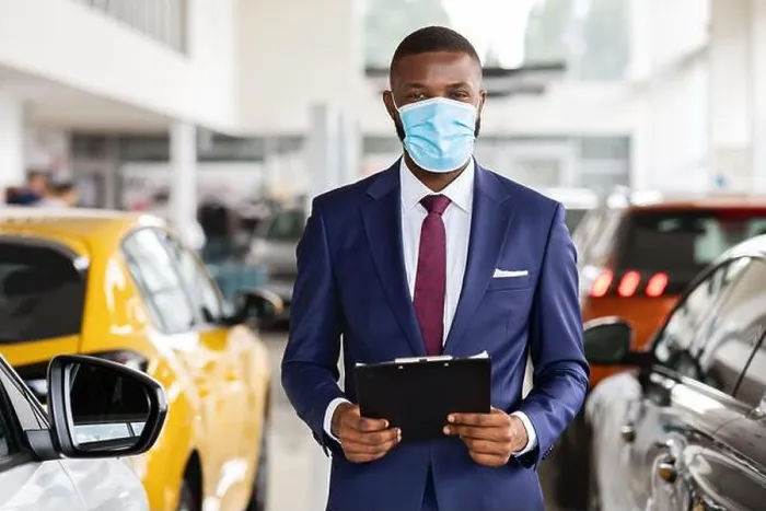 Framed Print : Young Black Car Salesman Wearing Medical Mask Posing At Workplace In Showroom Framed Print : Young Black Car Salesman Wearing Medical Mask Posing At Workplace In Showroom