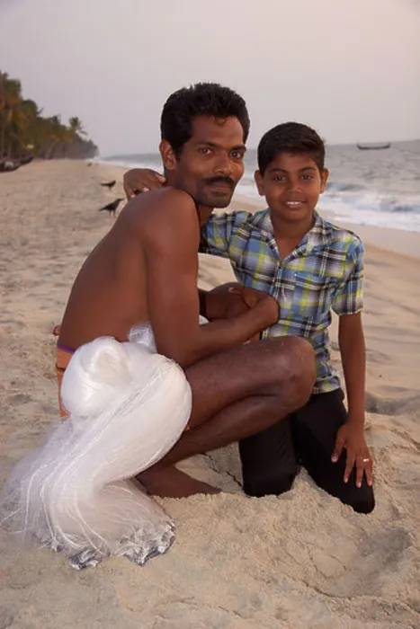 Framed Print : Young boy with his fisherman father on the beach at Kattoor Kalavoor Alappuzha Alleppey Kerala India