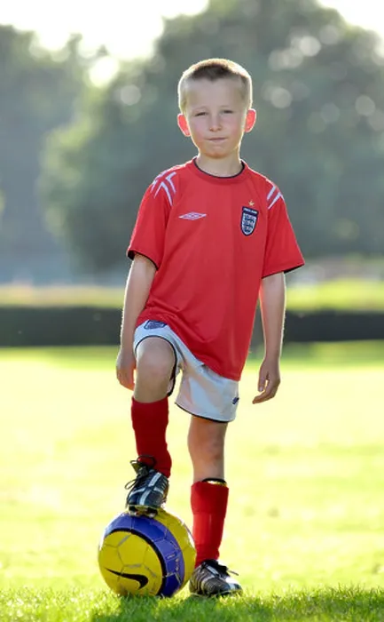 Framed Print : Young Boy Standing with Football Framed Print : Young Boy Standing with Football