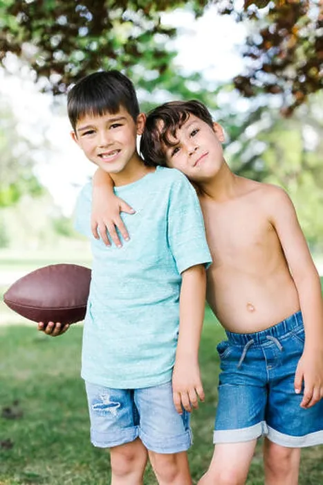 Framed Print : Young boys (6-7, 8-9) with american football ball Framed Print : Young boys (6-7, 8-9) with american football ball
