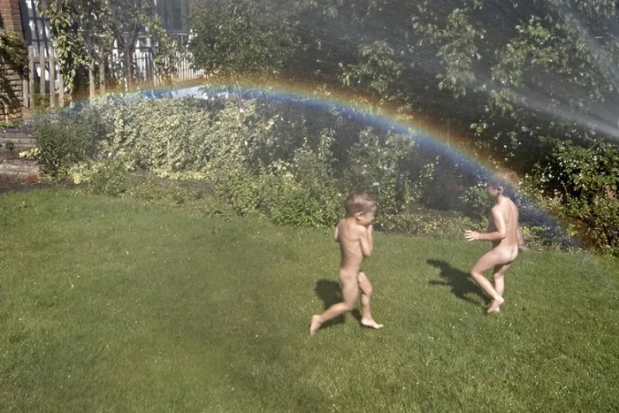 Framed Print : Two young boys or children playing with a hose in a suburban garden in summer with a rainbow in the spray London Framed Print : Two young boys or children playing with a hose in a suburban garden in summer with a rainbow in the spray London