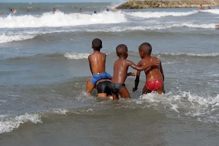 Framed Print : Four young boys playing in the Caribbean sea in Cartagena, Colombia Framed Print : Four young boys playing in the Caribbean sea in Cartagena, Colombia