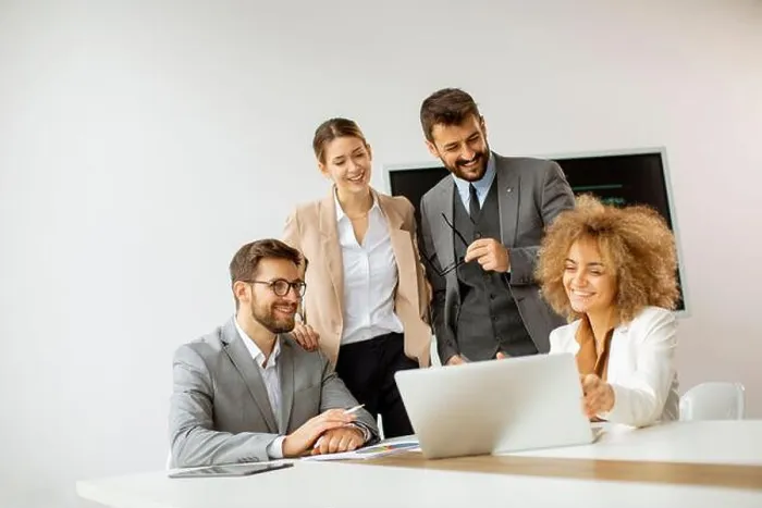 Framed Print : Young business people sitting at meeting table in conference room discussing work and planning strategy Framed Print : Young business people sitting at meeting table in conference room discussing work and planning strategy