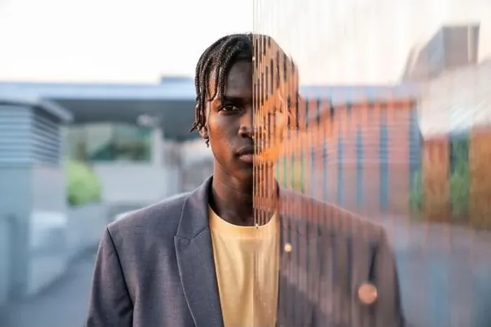 Framed Print : Young businessman in front of metal wall