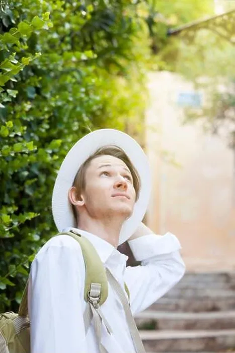 Framed Print : A young Caucasian man in a white hat walks along the street of the old city. Anafiotika. Athens. Greece Framed Print : A young Caucasian man in a white hat walks along the street of the old city. Anafiotika. Athens. Greece
