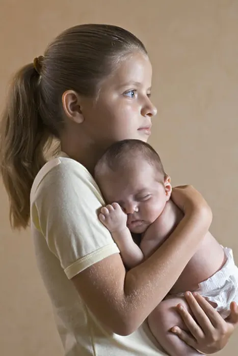 Framed Print : A young girl holding her baby sister closely Framed Print : A young girl holding her baby sister closely