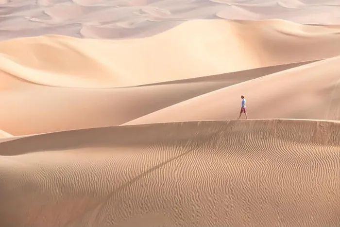 Framed Print : Young handsome caucasian tourist in shorts and straq hat hiking in Liwa desert dunes. Abu Dhabi, UAE Framed Print : Young handsome caucasian tourist in shorts and straq hat hiking in Liwa desert dunes. Abu Dhabi, UAE