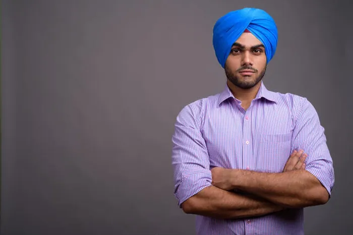 Framed Print : Young handsome Indian businessman wearing turban against gray ba Framed Print : Young handsome Indian businessman wearing turban against gray ba