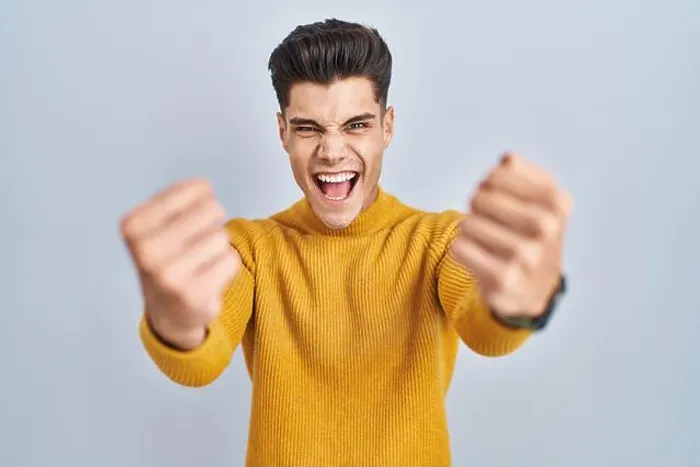 Framed Print : Young hispanic man standing over blue background angry and mad raising fists frustrated Framed Print : Young hispanic man standing over blue background angry and mad raising fists frustrated