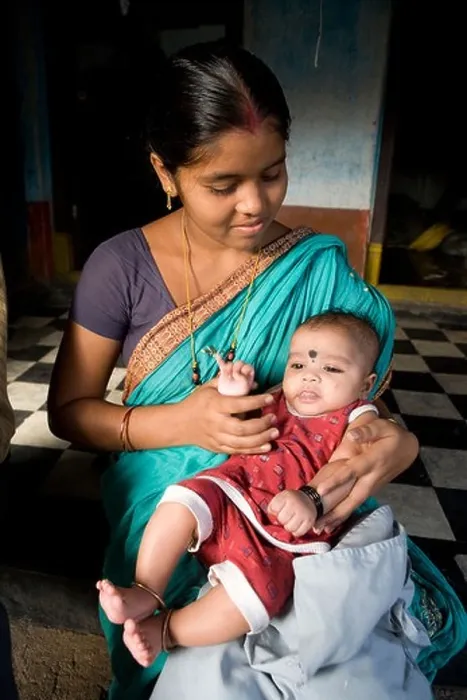 Framed Print : Young Indian mother with her son in her house at the fisherman village in Puri, Orissa, India Framed Print : Young Indian mother with her son in her house at the fisherman village in Puri, Orissa, India