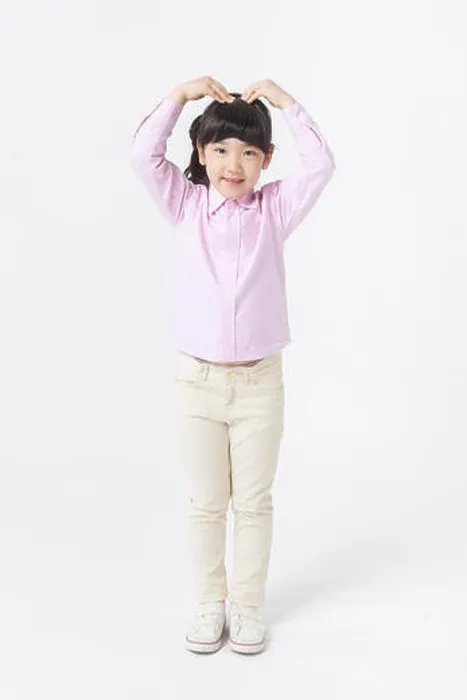 Framed Print : Young Korean girl in pink shirt putting her hand up and making heart shape with arms Framed Print : Young Korean girl in pink shirt putting her hand up and making heart shape with arms