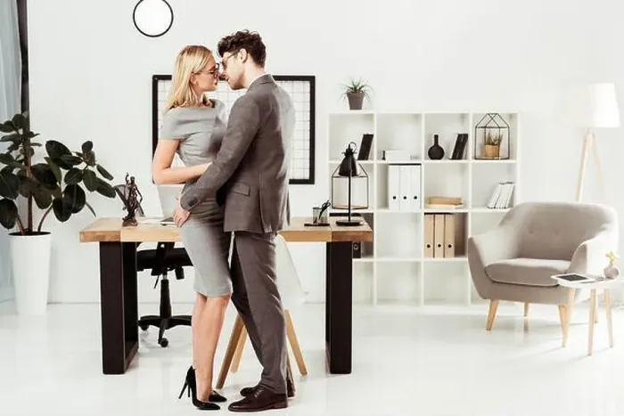 Framed Print : young lawyers hugging each other while standing in office, flirt and office romance concept