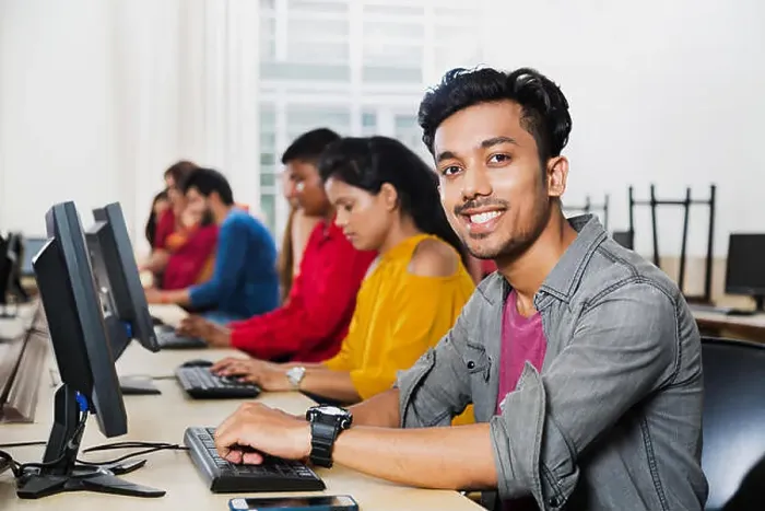 Framed Print : Young Male College Student Using Computer Studying E-Learning Education With Students In Computer Class Framed Print : Young Male College Student Using Computer Studying E-Learning Education With Students In Computer Class