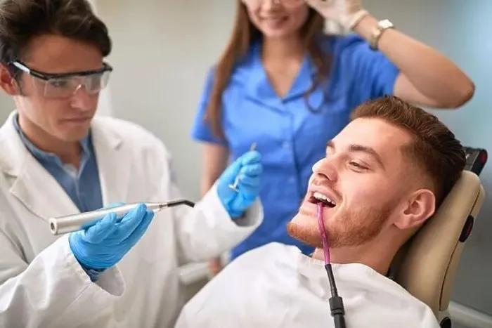 Framed Print : Young man at dentist repairing teeth Framed Print : Young man at dentist repairing teeth