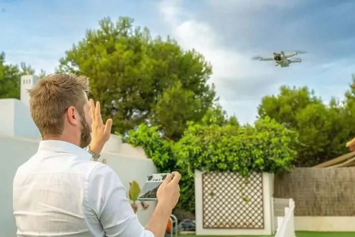 Framed Print : Young man launches a drone into the sky Framed Print : Young man launches a drone into the sky
