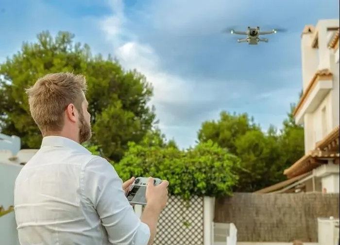 Framed Print : Young man launches a drone into the sky Framed Print : Young man launches a drone into the sky
