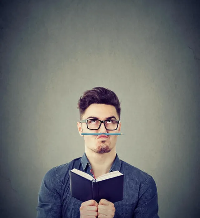 Framed Print : Young man with notepad playing with pencil instead of moustache fighting with boredom Framed Print : Young man with notepad playing with pencil instead of moustache fighting with boredom