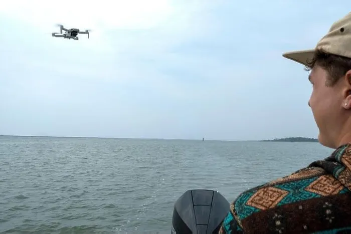 Framed Print : Young man operating aerial photography drone on a small boat Framed Print : Young man operating aerial photography drone on a small boat
