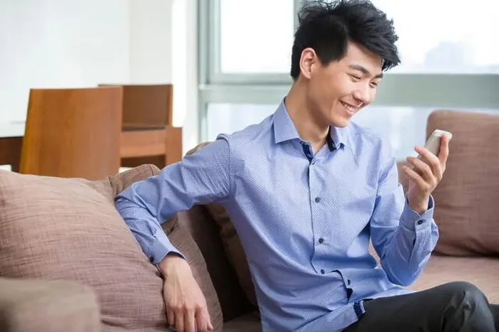 Framed Print : Young man using smart phone Framed Print : Young man using smart phone