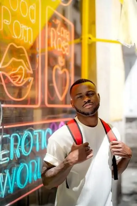 Framed Print : Young man wearing casual clothing in front of neon lights on window Framed Print : Young man wearing casual clothing in front of neon lights on window