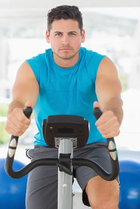 Framed Print : Serious young man working out at spinning class Framed Print : Serious young man working out at spinning class