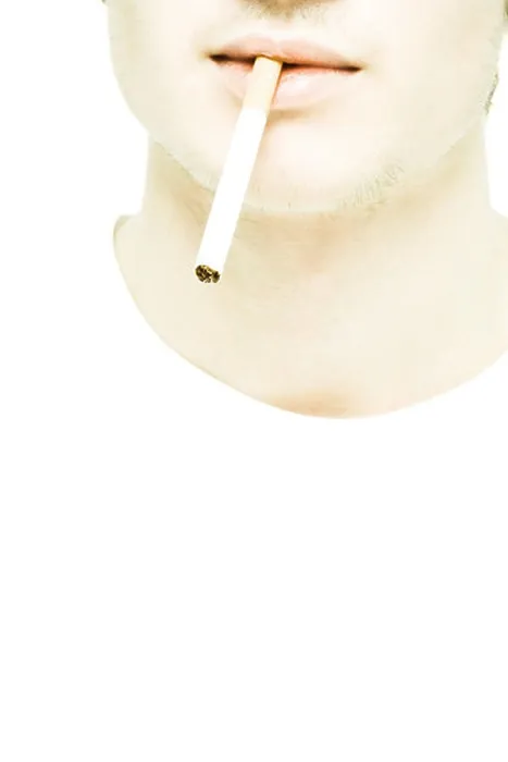 Framed Print : Young man's lower face, cigarette between lips, extreme close-up Framed Print : Young man's lower face, cigarette between lips, extreme close-up
