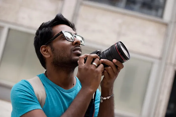 Framed Print : young photographer holding a camera