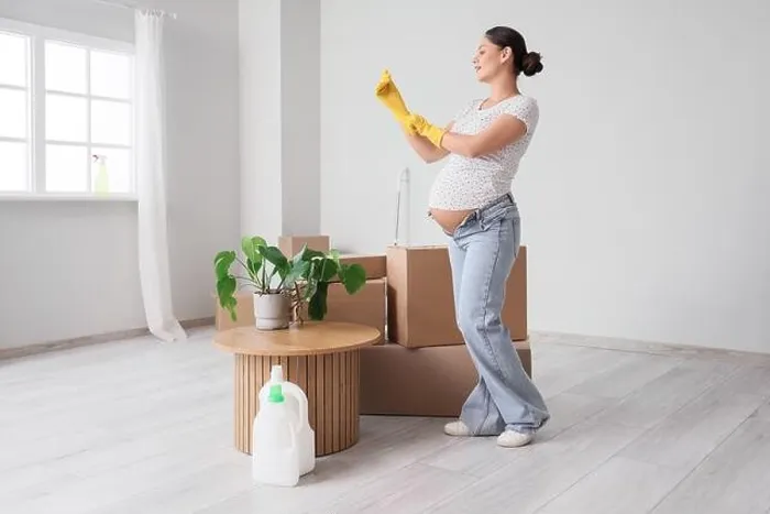 Framed Print : Young pregnant woman with rubber gloves preparing for cleaning in new apartment Framed Print : Young pregnant woman with rubber gloves preparing for cleaning in new apartment