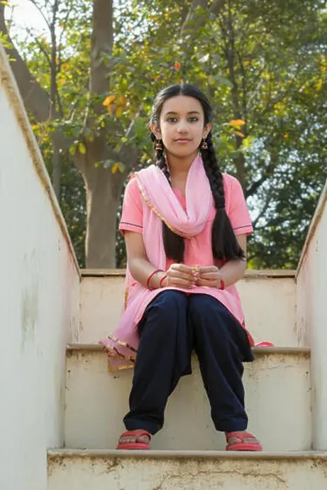 Framed Print : Young village girl sitting on the steps of her house leading to the terrace Framed Print : Young village girl sitting on the steps of her house leading to the terrace