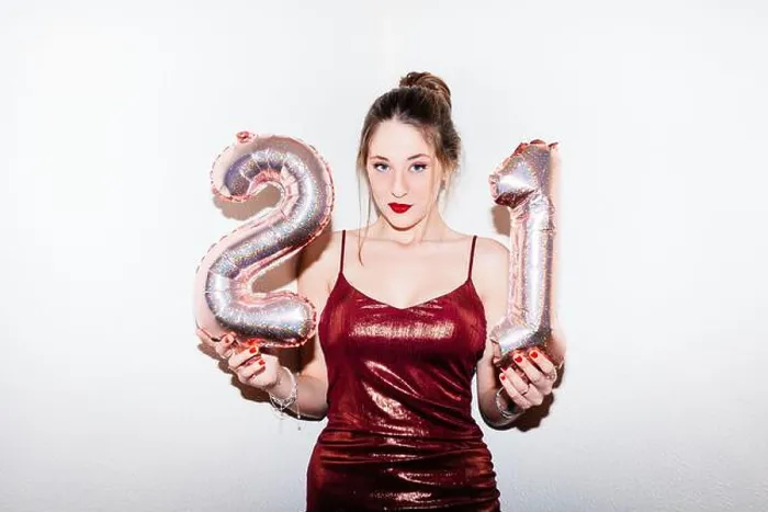 Framed Print : Young woman celebrating her 21st birthday illuminated with hard flash light Framed Print : Young woman celebrating her 21st birthday illuminated with hard flash light